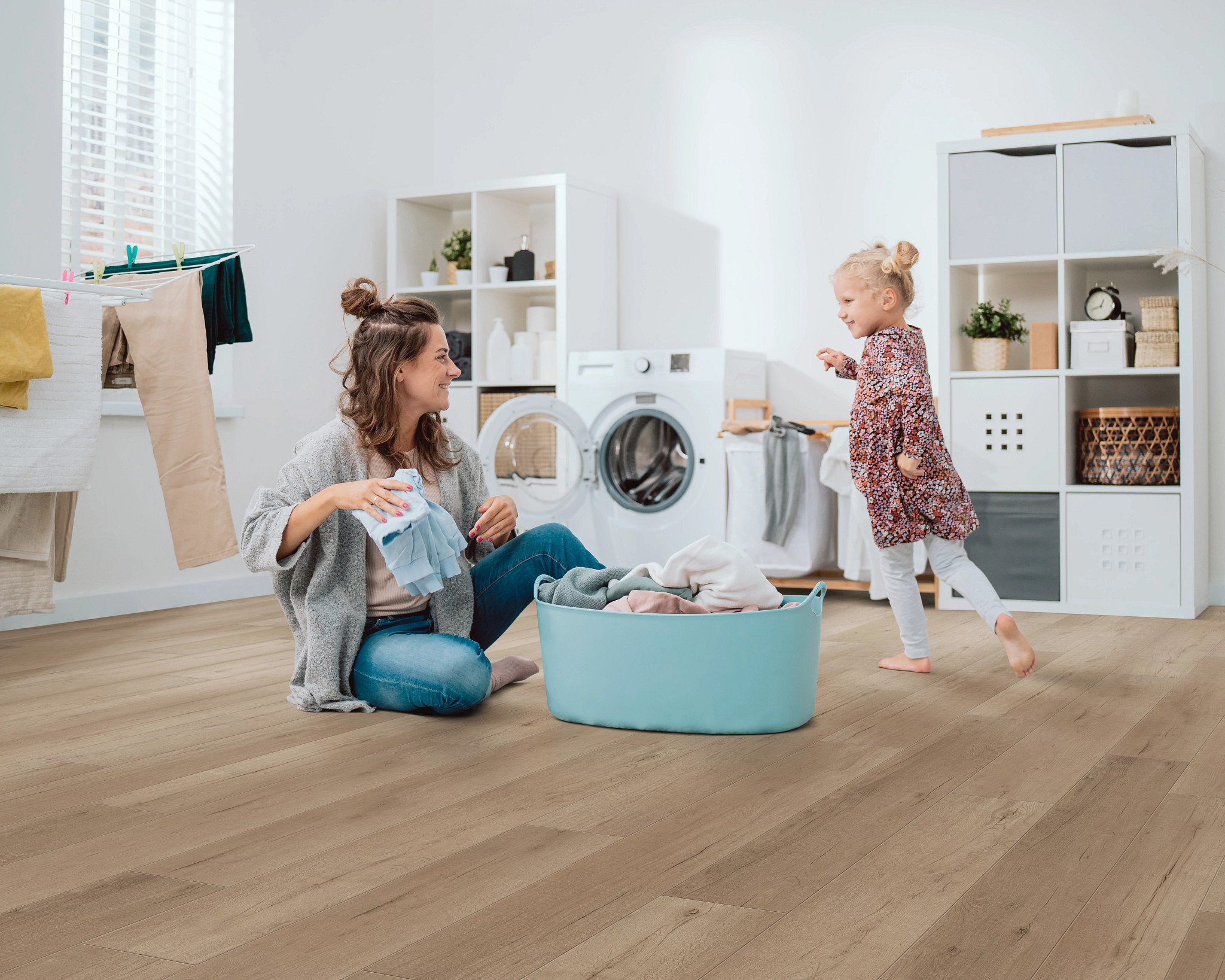 laundry mother and child on laundry room floor warm grey vinyl floor